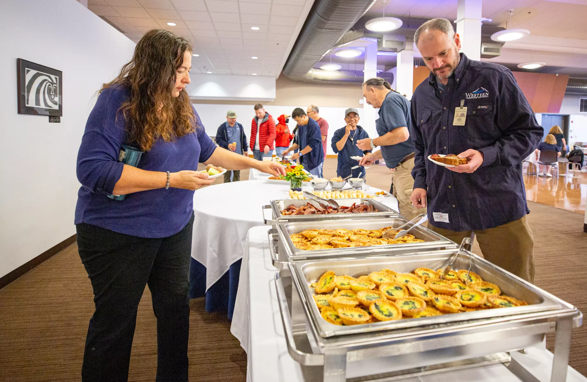 People taking food from catering trays