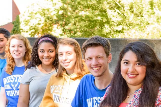 A group of students stand in a line
